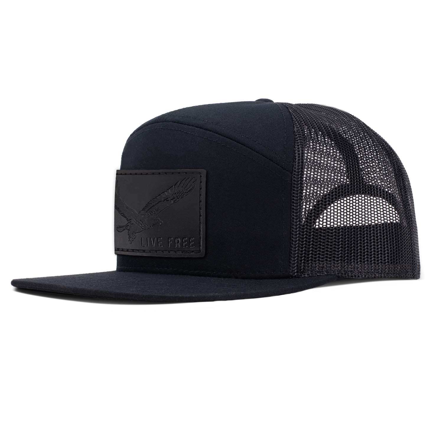 Revolution Mfg black with black mesh 7 panel trucker featuring our full grain leather black Live Free patch on the seamless front panel.