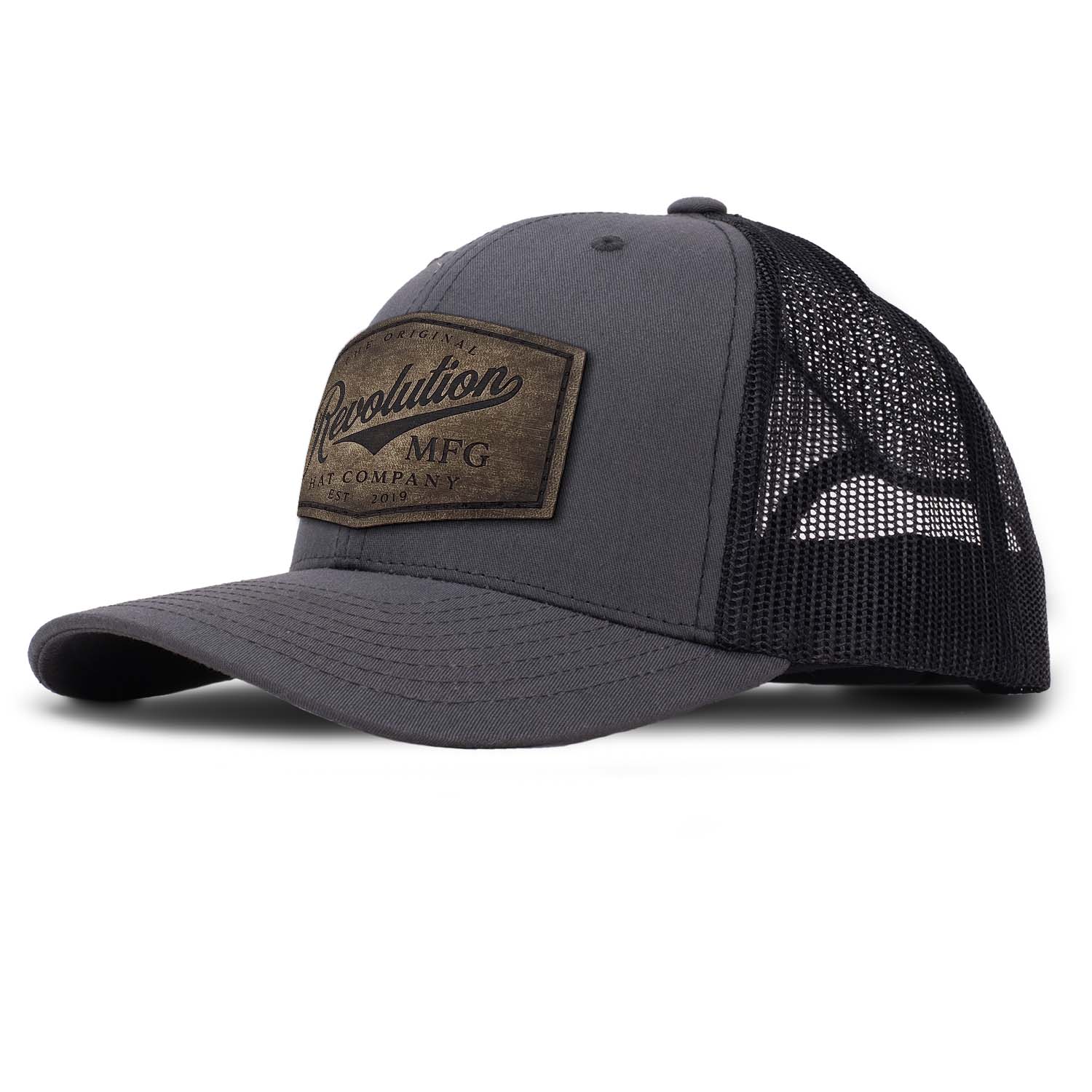 Revolution Hat Co full grain leather patch in a vintage finish on a charcoal with black mesh classic trucker hat