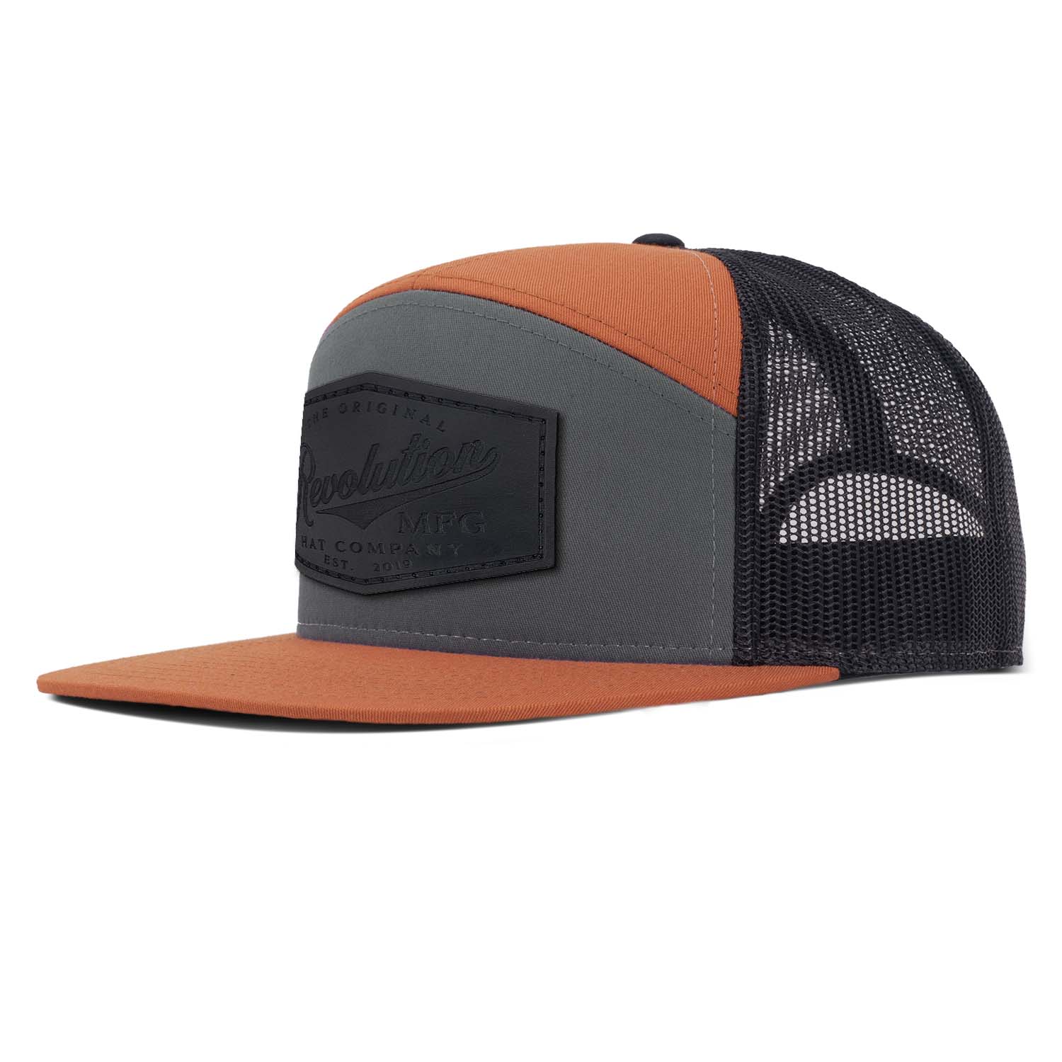 Revolution Mfg charcoal and burnt orange with black mesh 7 panel trucker featuring our full grain black leather Revolution Hat Co patch on the seamless front panel.