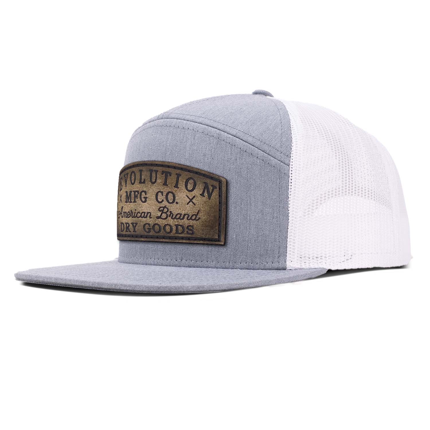 Revolution Mfg heather gray with white mesh 7 panel trucker featuring our vintage full grain leather Dry Goods patch on the seamless front panel.