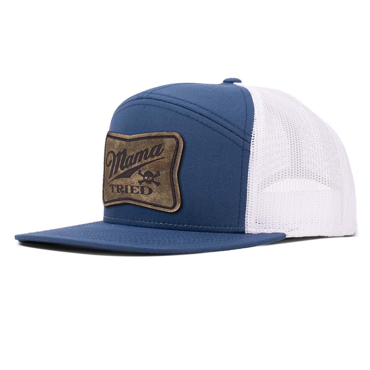 A navy 7 panel trucker hat with white mesh featuring our full grain leather vintage finish Mama Tried patch stitched on the seamless front panel
