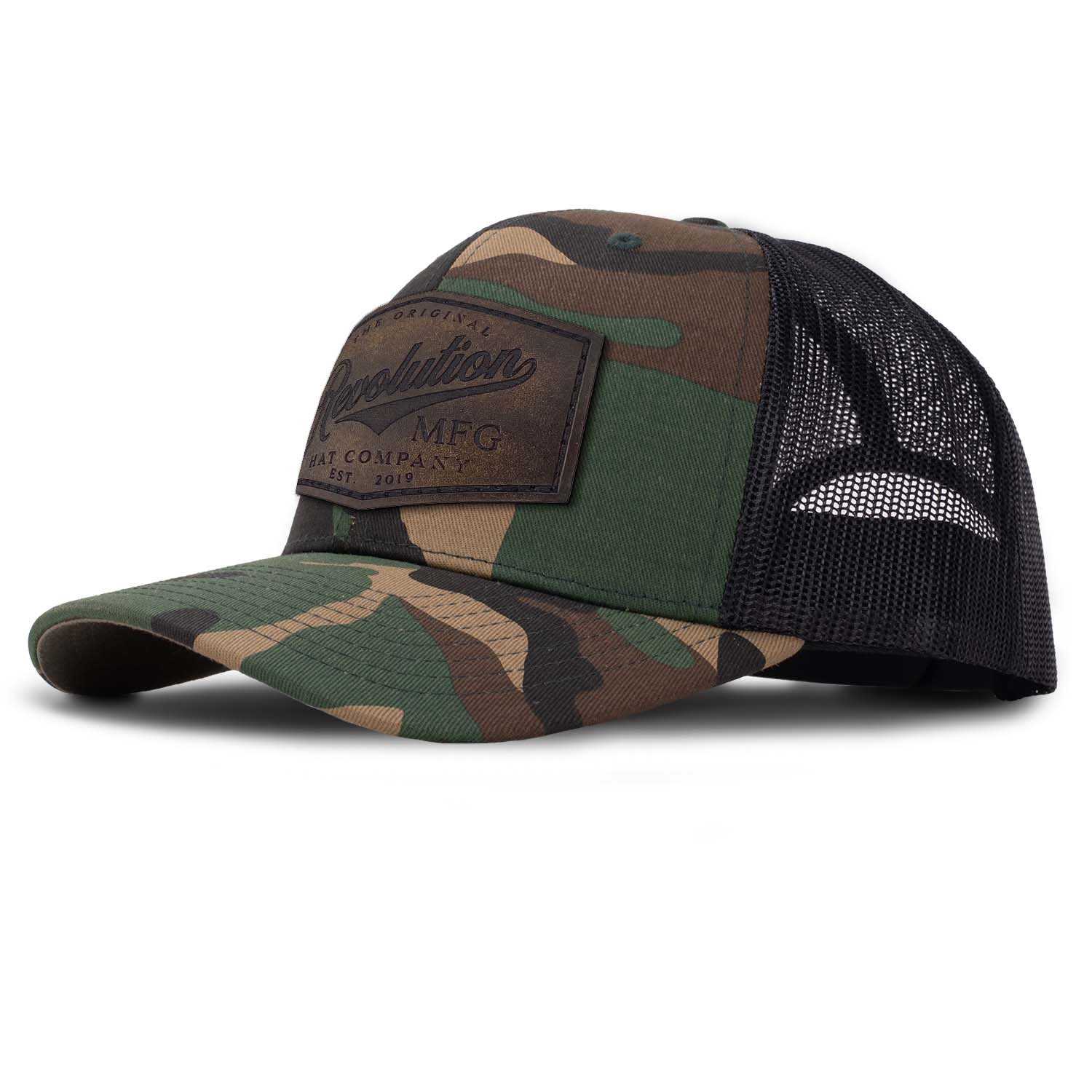Revolution Mfg Hat Co full grain leather patch on a classic woodland camo trucker hat with black mesh