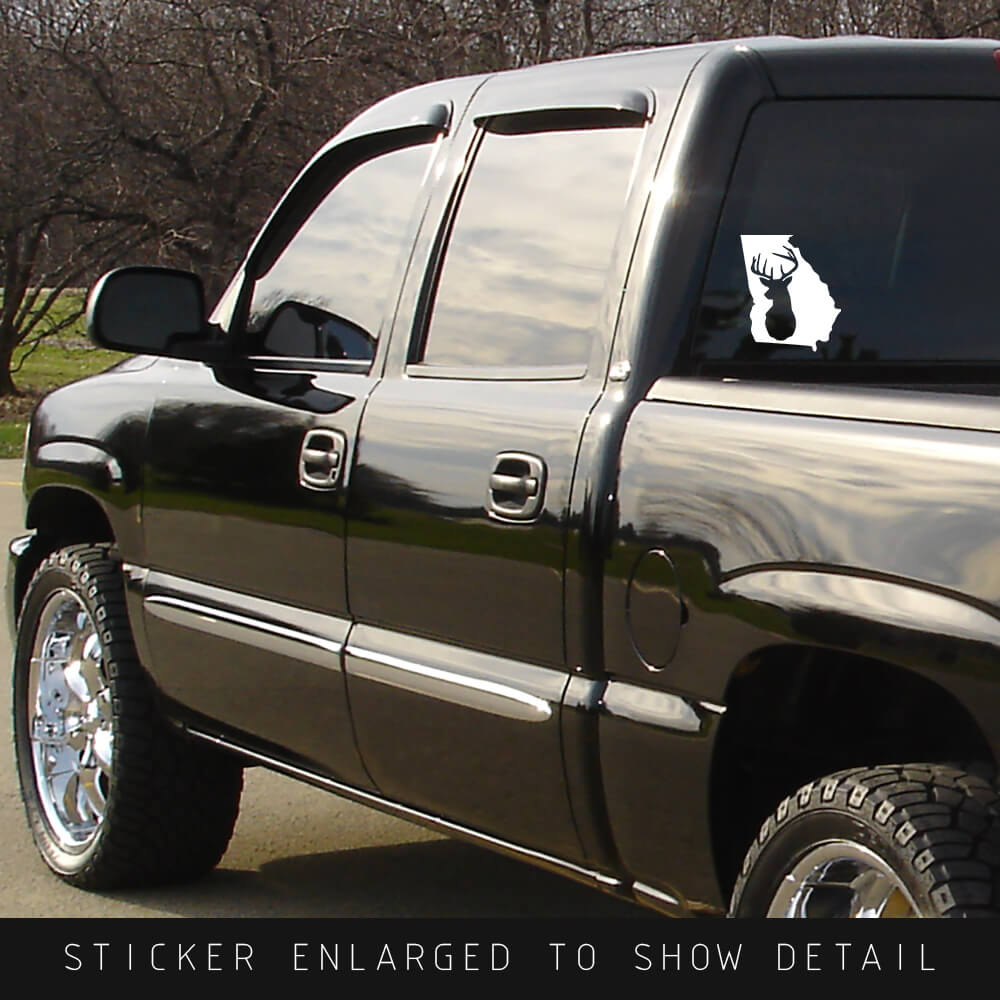 American Made white vinyl Georgia state die cut decal with whitetail deer silhouette cut out shown on back window of black truck