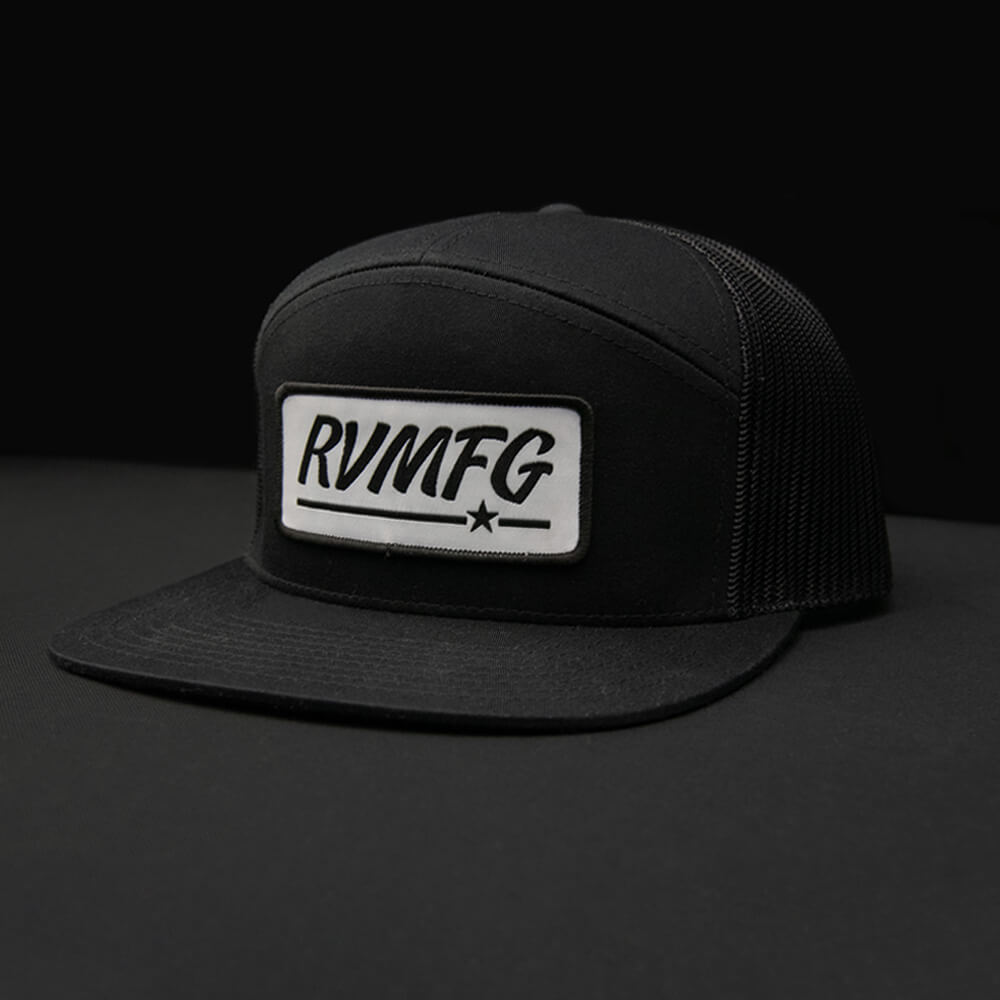 Black 7 panel RVMFG trucker hat with white custom woven patch