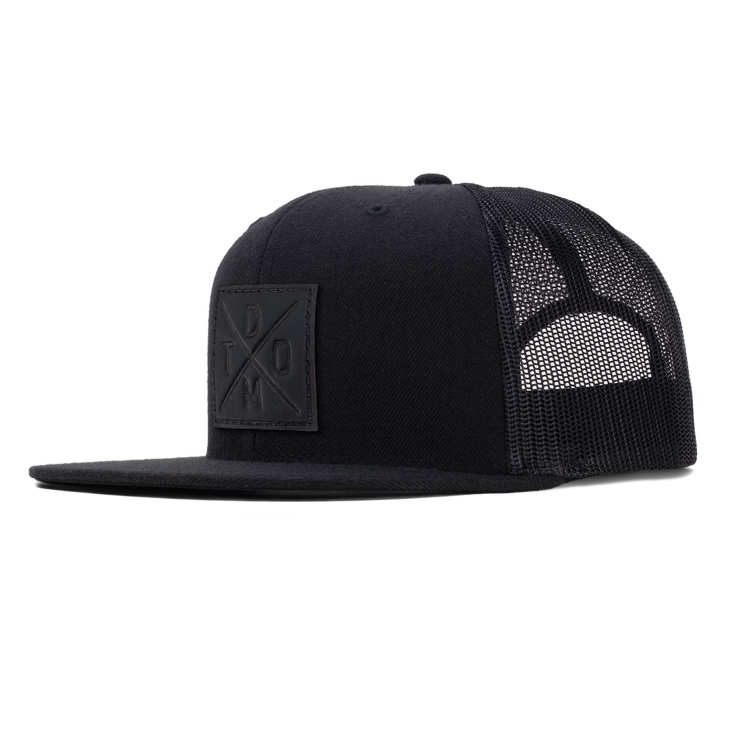 Black full grain leather debossed square DTOM patch on a black flat bill hat with black mesh