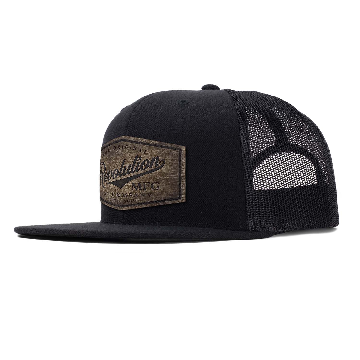 A classic flat bill trucker in black with black mesh with a full grain leather Revolution Hat Co patch in our vintage finish