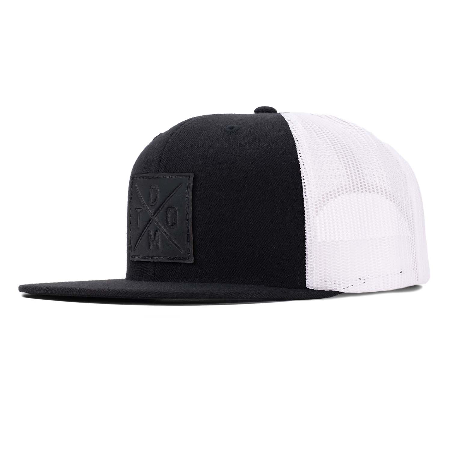 Black full grain leather debossed square DTOM patch on a black flat bill hat with white mesh