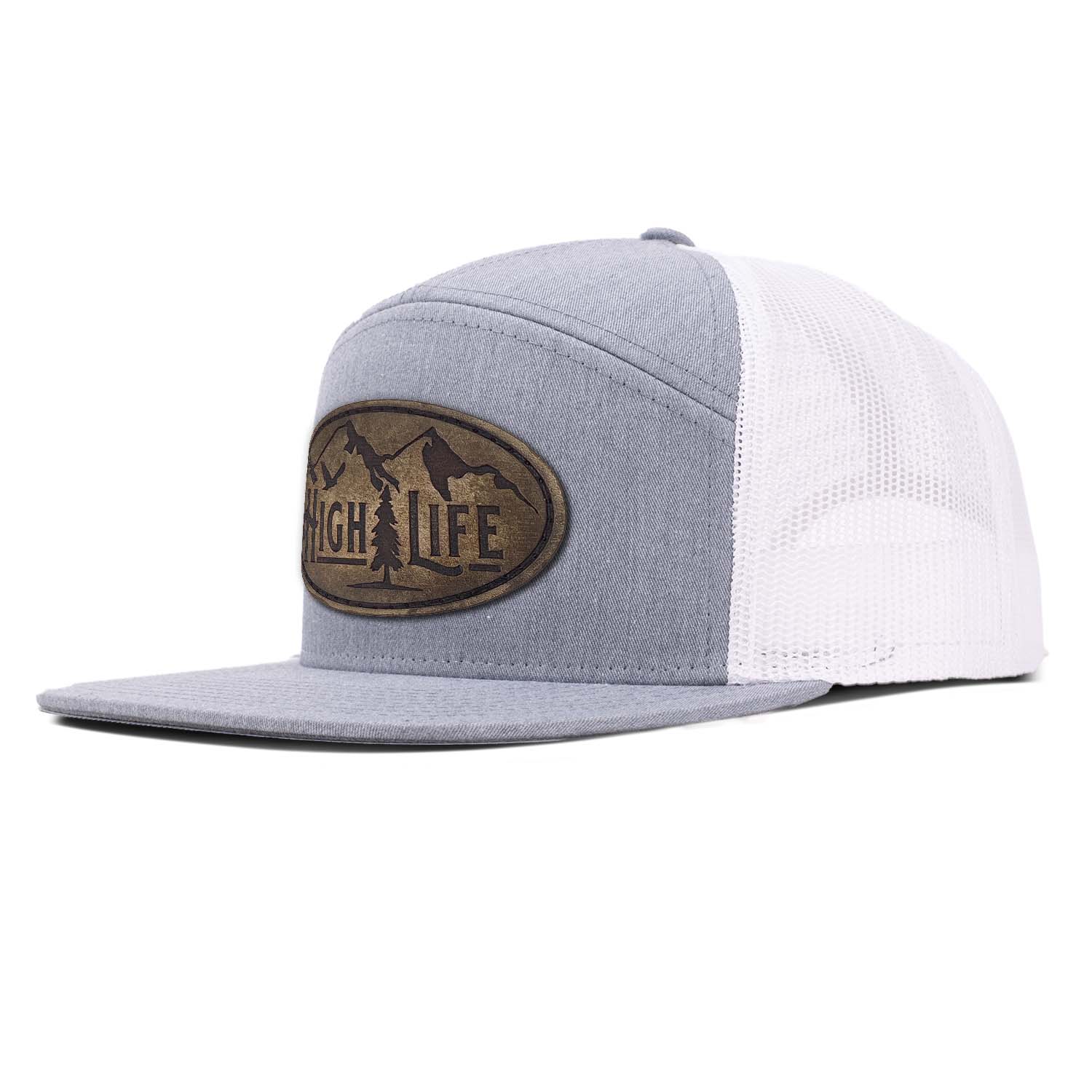 Revolution Mfg heather gray 7 panel trucker hat with white mesh featuring our full grain leather vintage finish High Life patch stitched on the seamless front panel