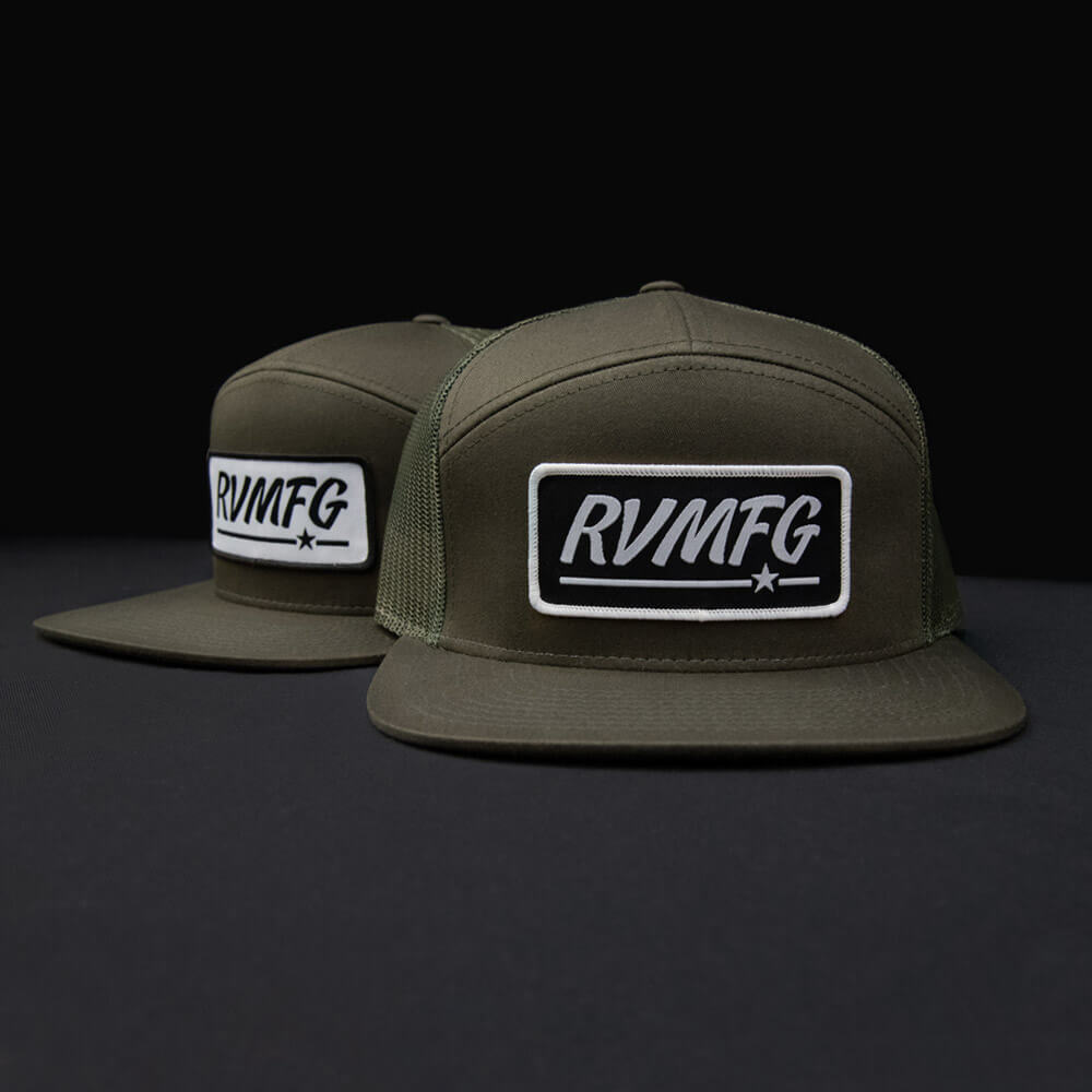 RVMFG Loden 7 Panel trucker hat featuring a flat bill and snapback. Available with a custom woven patch in either black or white.