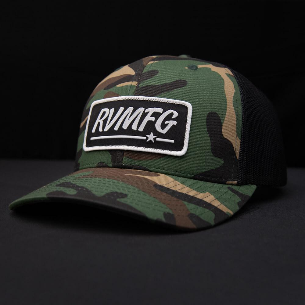 Woodland Camo and Black classic trucker patch hat shown with black background woven RVMFG patch