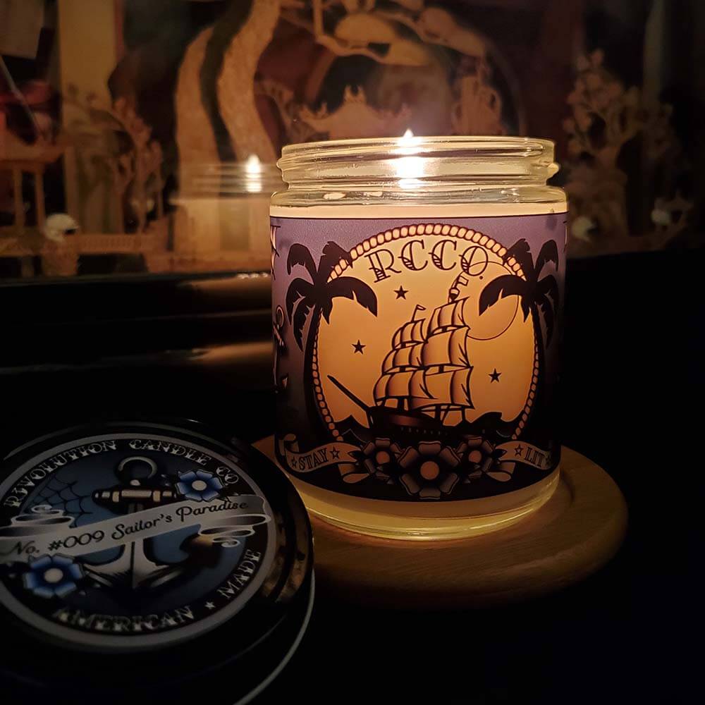 American Made Traditional Tattoo-inspired designs Sailor's Paradise tropical scent Soy blend candle Revolution Candle Co Palm trees Blue Flowers Ship Sailing under moon and stars Old School anchors